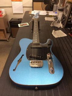 a blue guitar sitting on top of a table