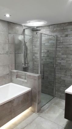 a bathroom with a walk in shower next to a bath tub