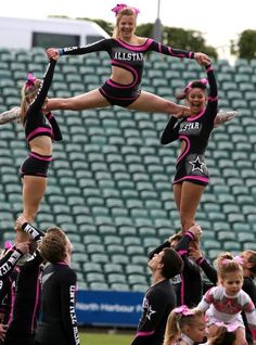 the cheerleaders are doing tricks for the crowd