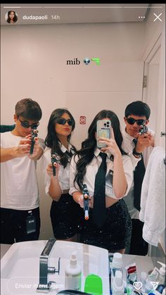 three people taking pictures in front of a mirror with their cell phones and ties on