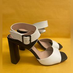 Whether You Choose To Dress Them Up Or Down, These Sleek Vegan Leather Single-Sole Block Heels Will Stun With Their Contrasting White Toe Strap And Adjustable Ankle Strap. Style Yours With Anything And Everything As These Sandals Will Always Look Versatile. Heel Height 4 2334 Modern White Sandals With 4-inch Heel, White Leather Heels With Buckle Closure, White Block Heel Workwear Heels, White Block Heel Shoes For Work, Chic White Sandals With Buckle Closure, White Heels With Buckle Closure For Evening, White Evening Heels With Buckle Closure, White Leather Open Heel Heels, White Block Heels For Office