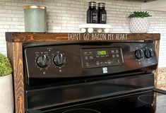 a black stove top oven sitting inside of a kitchen