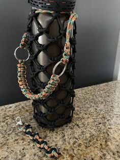 a bottle that has some kind of chain attached to it, and is sitting on a counter