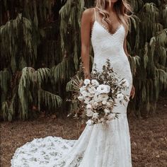 a woman in a wedding dress holding a bouquet