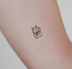 a small dog tattoo on the arm