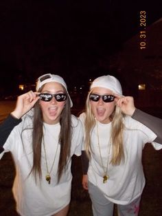 two young women wearing sunglasses and white shirts