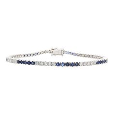 This 14K White Gold Sapphire and Diamond Tennis Bracelet features 36 round cut sapphires totaling 2.5 carats and 35 round cut diamonds totaling 1.77 carats. Each gemstone is securely held in place with a 4-prong setting.  This bracelet measures 7 inches in length and 2.3mm width and weighs 8.14 grams, and is secured with a box clasp.  Details:   Item Type: Tennis Bracelet  Metal: 14K White Gold  Weight: 8.14 Grams   Length: 7 inches  Width: 2.3mm  Setting: Prong  Clasp: Box  Stone Details:  Gemstone: Sapphire  Cut: Round  Quantity: 36  Carat: 2.5 CTTW  Color: Blue  Secondary Stone Details:  Gemstone: Diamonds  Cut: Round  Quantity: 35  Carat: 1.77 CTTW  Color: White Classic Sapphire Tennis Bracelet With Prong Setting, Classic Sapphire Diamond Tennis Bracelet, Classic Sapphire Tennis Bracelet With Brilliant Cut, Sapphire Tennis Bracelet With Round Diamonds, Sapphire Tennis Bracelet With Prong Setting, Sapphire Diamond Tennis Bracelet With Round Cut, Sapphire Diamond Tennis Bracelet With Round Shape, White Gold Sapphire Tennis Bracelet With Brilliant Cut, Blue Diamond Bracelet With Brilliant Cut