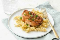 a white plate topped with pasta and meat