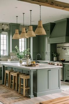 a large kitchen with green cabinets and wooden stools in front of an island counter