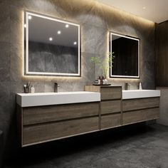 a bathroom with two sinks and mirrors on the wall above them is lit by lights