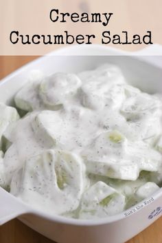 creamy cucumber salad in a white bowl on a wooden table with text overlay