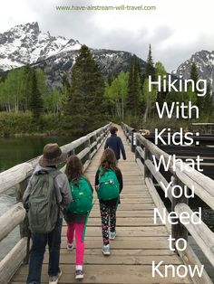 three children walking across a bridge with the words hiking with kids what you need to know