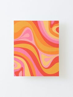 an orange and pink abstract painting on a white wall