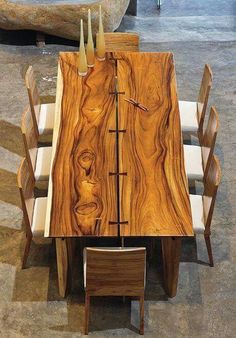 a wooden table with chairs around it