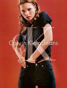 a woman in black shirt and jeans posing with her hands on her hips