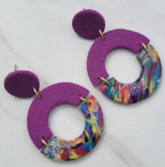 These earrings pair nicely with a t-shirt or sweater for a casual look. Or try a blouse for a bit more of a dressier look. Perfect for that back to school wardrobe! Go ahead and make a colorful statement. They are handmade, lightweight, casual, and make a perfect gift.  Push backs and jump rings are stainless steel or gold plated stainless steel.  **Purple is the only option available in gold or stainless steel ** CARE INSTRUCTIONS: Earrings should be stored in a dry place and cleaned gently wit Purple Dangle Earrings, Pride Jewellery, Casual Earrings, Light Weight Jewelry, Retro Earring, Mother Of Pearl Jewelry, Rainbow Jewelry, Spring Jewelry, Purple Earrings