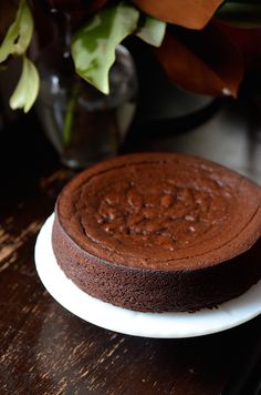 a chocolate cake sitting on top of a white plate