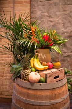 a wooden barrel filled with lots of different types of fruits and vegtables