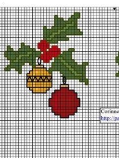 a cross stitch christmas ornament with holly and bauben hanging from it