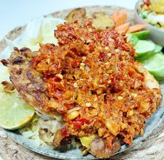 a plate topped with meat covered in sauce and vegetables