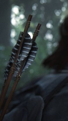 a woman holding two arrows in her hand