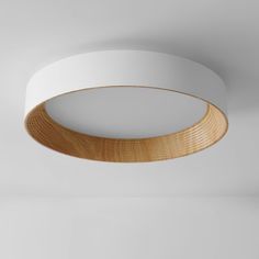 a circular wooden light fixture hanging from the ceiling