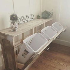 a wooden shelf with bins on top of it