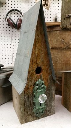 a birdhouse made out of wood with a green door