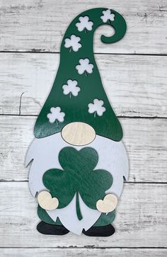 a green and white gnome with four leaf clovers