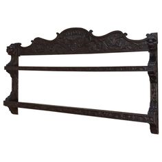 an old iron headboard with ornate carvings on the top and bottom, against a white background