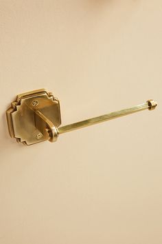 an old brass door handle on a white wall