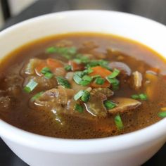 a close up of a bowl of soup on a table