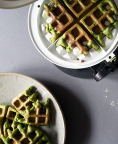 waffles with green toppings are on plates