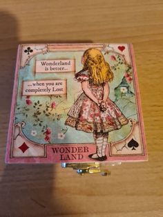 a wooden table with a card on it that says wonderland is better when you are completely lost