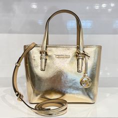 New With Tag Michael Kors Jet Set Travel Xs Carryall Tote Top Zip Satchel Shoulder Bag Patent Vegan Leather Pale Gold 100% Authentic Retail: $498.00 Plus Tax **Please See The Measurement For The Size** !No Dust Bag! Michael Kors Logo At Front Gold Toned Hardware Zip Top Closure Slip-In Pocket One Mk Charm Custom Fabric Lining 1 Slip-In Pocket, 1 Zipper Pocket 9"(Top) 11"(Bottom) X 7.75" (H) X 4.25"(D) Strap: 5", 24" Very Clean, Smoke-Free And Pet-Free Environment. Classic Gold Shopping Bag, Michael Kors Gold Bag With Adjustable Strap, Gold Michael Kors Bag With Adjustable Strap, Michael Kors Gold Top Handle Bag, Everyday Gold Bag With Branded Hardware, Gold Michael Kors Top Handle Bag, Gold Shoulder Bag With Dust Bag For On-the-go, Gold Bag With Branded Hardware For Everyday, Gold Everyday Bag With Branded Hardware