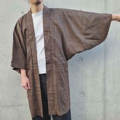 This Haori Jacket, crafted from vintage Japanese kimono fabric, is a lightweight overshirt with a loose fit and traditional Japanese styling. It's ideal for a light spring layer. Colour- Dark brown Size- One size Length: 99 cm / 39.0" Pit to pit: 60 cm / 23.6" Sleeve: 66 cm / 26.0" Fit- Male model's height: 180cm / 5'11" Female model's height: 173cm / 5'8" Composition, origin & condition- Mixed cotton We carefully source authentic vintage kimonos, personally selected in Japan. This kimono fabric Noragi Jacket, Japanese Haori, Haori Jacket, Spring Layers, Vintage Japanese Kimono, Style Japonais, Coat Vintage, Kimono Fabric, Light Spring