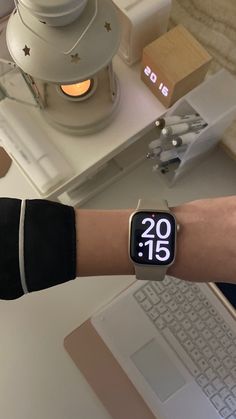 an apple watch on someone's wrist with the time displayed in front of them