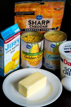 some food is sitting on a table with milk, yogurt and other items