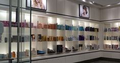 the shelves are filled with many different types of hair care products and perfumes on display