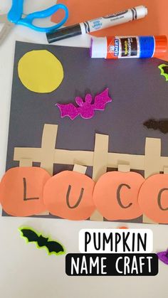 a paper pumpkin name craft with scissors and glue