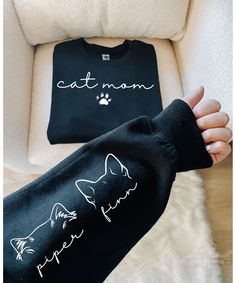 someone is holding their arm up to show the cat mom t - shirt on it