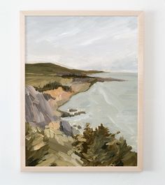 a painting hanging on the wall next to a white wall with a wooden frame and an ocean view