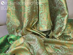 the fabric is green and gold in color