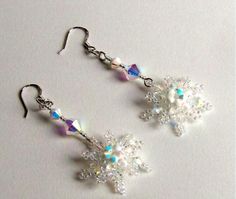 the earrings are made out of glass beads and swarong crystal flowers on them