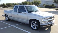 a silver truck parked in a parking lot