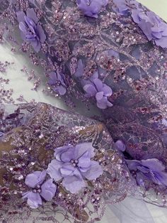 purple lace with flowers and sequins on it