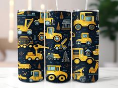 three tumblers with construction themed designs on them