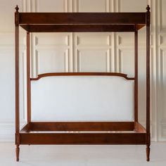 a wooden bed frame sitting on top of a white floor