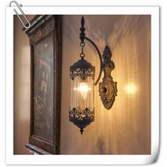 an old fashioned light fixture hanging from the side of a wall