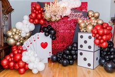 a room with balloons and cards on the floor